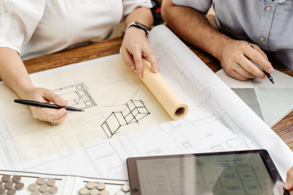 Duoma Atelier team reviewing construction plans for an Italian villa